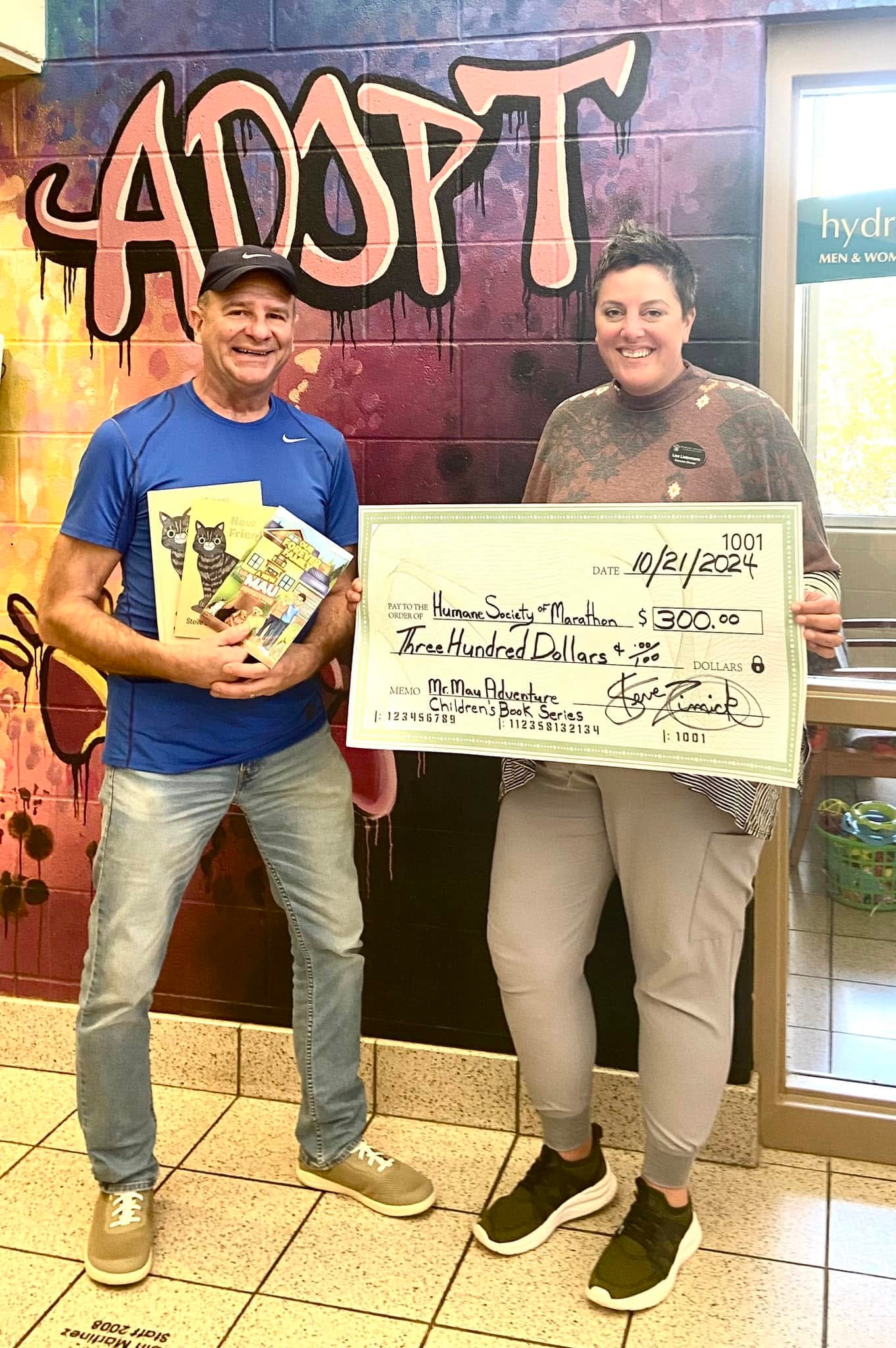 Two people holding charity donation check